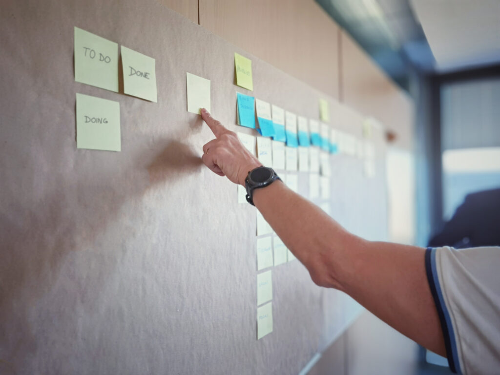 IT worker tracking his tasks on kanban board