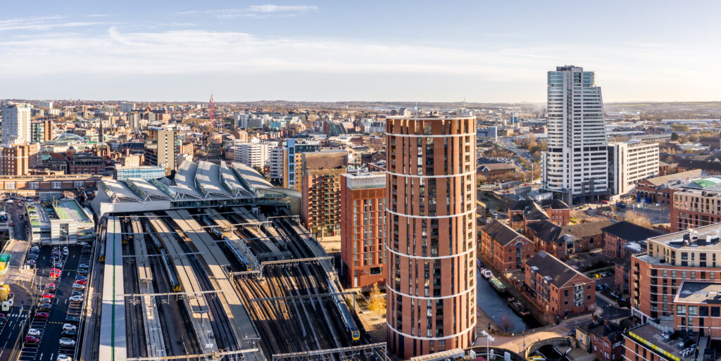 An aerial cityscape view of Leeds railway station and the city centre